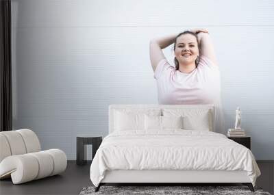 Fat woman doing stretching exercise Wall mural