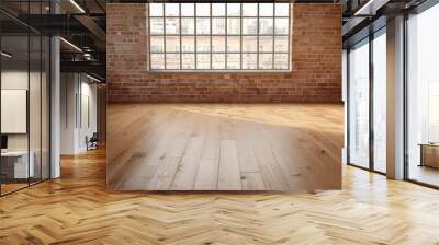 Empty loft-style room with large window, natural light, wooden floor, and exposed brick walls exudes industrial charm. Wall mural