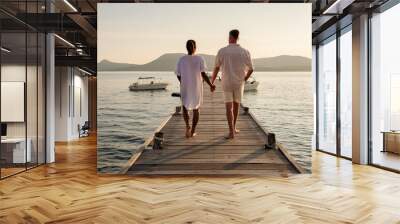 A couple at a wooden pier in the ocean during sunset in Samaesan Thailand Wall mural