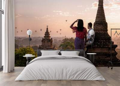 Bagan Myanmar couple torusit men and woman visit the historical site of Pagan a Unesco world heritrage during sunrise Wall mural