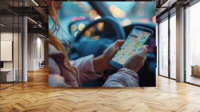 Close up hand woman using navigation on mobile smartphone. Blurred car interior background. Viewing location map in a network via smartphone during road trip Wall mural