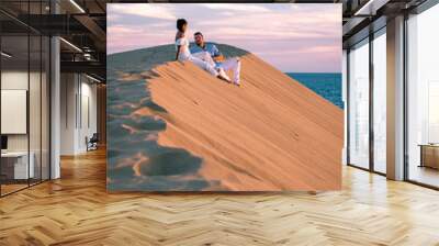 couple walking at the beach of Maspalomas Gran Canaria Spain, men and woman at the sand dunes desert of Maspalomas Wall mural