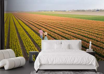 Men and women in flower fields seen from above with a drone in the Netherlands, flower fields Wall mural