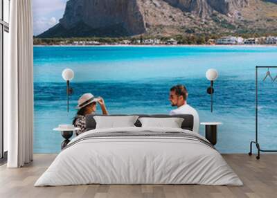 San Vito Lo Capo Sicilia, couple of men and woman visiting the beach of San Vito Lo Capo Sicily Italy Wall mural