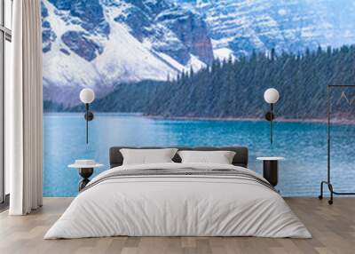 The beautiful Lake moraine at sunset, Beautiful turquoise waters of the Moraine lake with snow-covered rocky mountains in Banff National Park of Canada , couple visit the lake men and woman mid age Wall mural