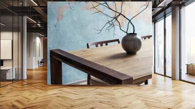 Close up of design wooden table with, stylish chairs, flowers in vase and elegant accessoreis. Details of home decor. Indusrtial concept of dining room. Open space. Template. Old wall. Wall mural