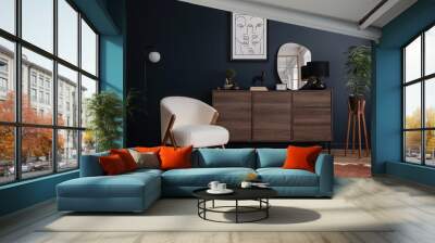 Elegant modern living room interior design with fluffy armchair, wooden commode, mock up poster frame and modern home accessories. Blue wall. Template. Copy space. Wall mural