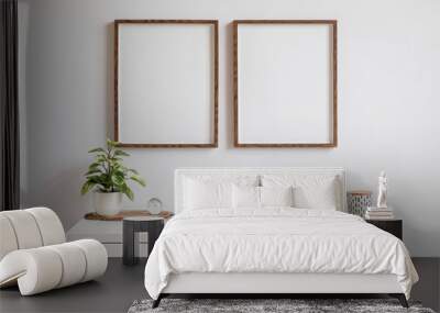 Minimalistic home decor of interior with two brown wooden mock up photo frames on the white shelf with books, beautiful plant in stylish pot and home accessories. White wall.  Wall mural