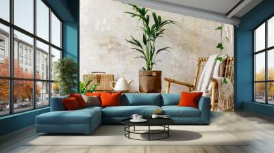 Neutral composition of living room interior with rattan armchair, wooden bench, a lot of tropical plants in design pots, decoration and elegant personal accessories in stylish home decor. Wall mural