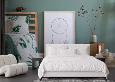 Stylish and modern composition of bedroom interior with wooden bed, mock up poster frame, cube, vase with flowers, books and elegant accessories. Beautiful bed sheets, blankets and pillow. Template. Wall mural