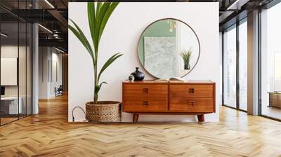 Stylish and retro composition of living room with design wooden retro commode, mirror, a lot of plants and elegant accessories. Modern home decor. Template. Mock up poster frame on the wall.  Wall mural