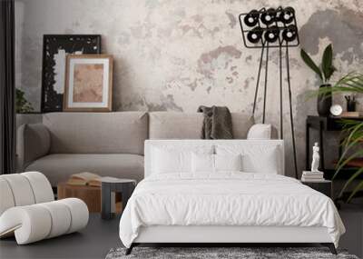 The stylish compostion at concrete living room interior with design gray sofa, wooden coffee table, desk and elegant personal accessories. Loft and industrial interior. Home decor. Template. . Wall mural