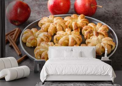 baked apples wrapped in puff pastry and sprinkled with sugar and cinnamon close-up in a plate on the table. horizontal Wall mural