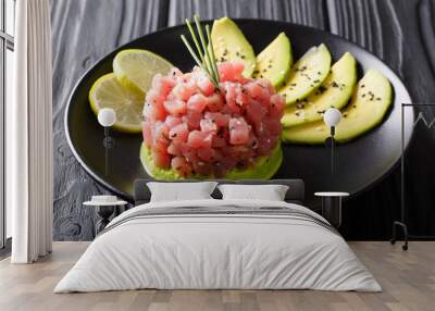 Beautiful food: fresh tuna tartar with lime, avocado and sesame close-up. horizontal Wall mural