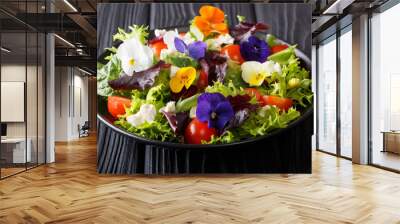 Beautiful healthy salad with edible flowers with fresh lettuce, spinach, tomatoes and cheese close-up. horizontal Wall mural