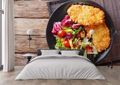 Chicken steak in breading Panko and fresh salad close-up on the table. horizontal top view Wall mural