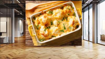 Delicious baked fresh cauliflower with cheese sauce close-up in a baking dish. horizontal top view Wall mural