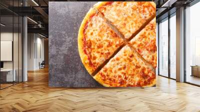 Delicious crispy New York style pizza with melted cheese and base tomato sauce close-up on a wooden board on the table. Horizontal top view from above Wall mural