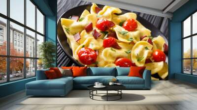 Delicious dumplings casoncelli with ham, cherry tomatoes and greens close-up. horizontal Wall mural