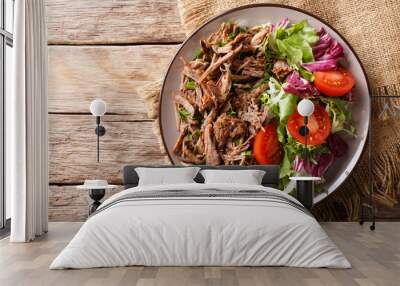 Delicious food: slow cooked pulled beef with fresh vegetable salad close-up. Horizontal top view from above Wall mural