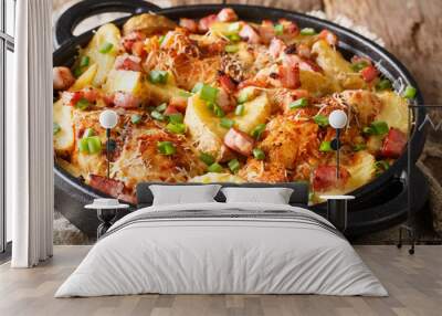 Delicious ranch casserole of chicken fillet with potatoes, bacon and cheese close-up in a pan. horizontal Wall mural