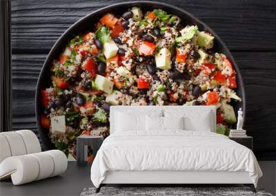 Dietary fitness salad of quinoa, avocado, pepper, tomatoes and black beans close-up in a plate. Horizontal top view Wall mural