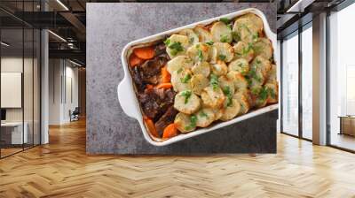 English Lancashire hot pot with meat and potato closeup in the baking dish on the table. Horizontal top view from above Wall mural