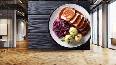 Festive German full dinner Sauerbraten - beef stew with gravy served with potato dumplings and red cabbage close-up. horizontal top view Wall mural