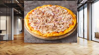 Fish pizza with tomato sauce, canned tuna, mozzarella cheese and red onion close-up on a wooden board on the table. Horizontal Wall mural