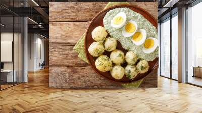 Frankfurt traditional dish of potatoes, boiled eggs and the famous green sauce close-up on a plate on the table. horizontal top view from above Wall mural