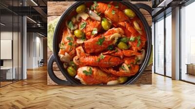 French food Chicken Marengo with crayfish, mushrooms, olives, tomatoes and shallots close-up in a pan on the table. horizontal top view from above Wall mural