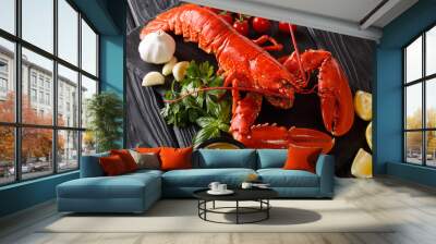 Freshly prepared lobster closeup with lemon, garlic, fresh tomatoes and herbs on a table. horizontal Wall mural