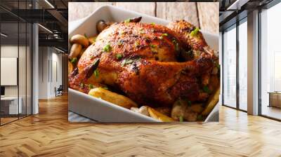 grilled chicken with mushrooms and potatoes close-up in a baking dish. horizontal Wall mural