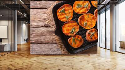 Grilled sweet potatoes with rosemary on the grill pan close-up. horizontal top view Wall mural