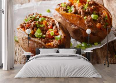 Homemade baked sweet potato stuffed with beef meat and green onions close-up on the table. horizontal Wall mural