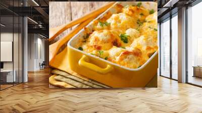 Hot appetizer: baked cauliflower with cheese cheddar close-up in a baking dish. horizontal Wall mural