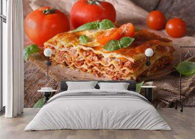 Italian lasagna with basil close-up on paper, horizontal rustic Wall mural