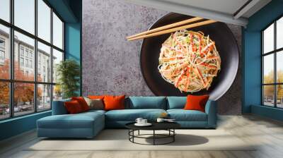 Kani or kanikama salad is a Japanese crab salad that is a delicious mix of crab meat crunchy cucumber and carrots and spicy mayonnaise dressing closeup in the plate on the table. Horizontal top view Wall mural