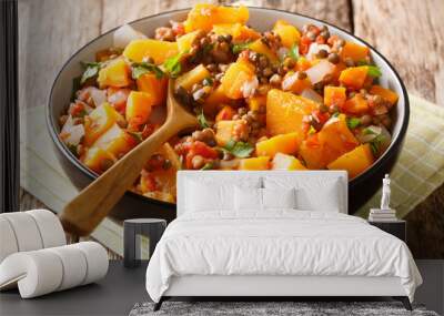 Low-calorie hot stew of pumpkin, lentils, onions and carrots close-up in a bowl. horizontal Wall mural