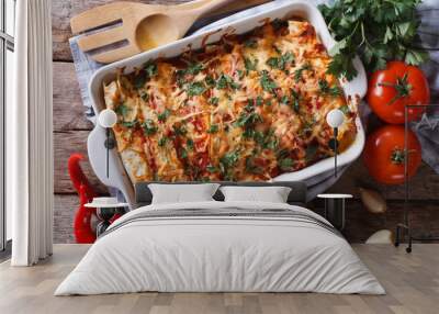 Mexican enchilada in a baking dish horizontal top view close-up Wall mural