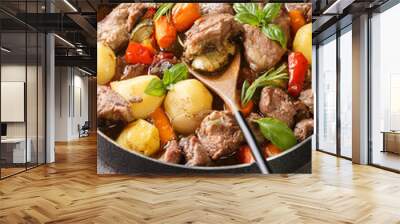 National Croatian food peka cooked with meat and vegetables over an open fire close-up on the table. vertical Wall mural