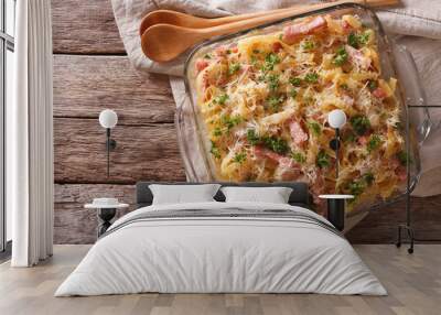 noodles baked with ham and cheese close-up in a baking dish. horizontal top view 
 Wall mural