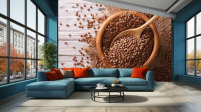 Raw brown lentils in a wooden bowl. horizontal top view
 Wall mural