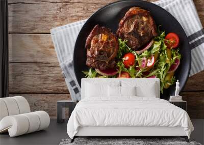 Roasted hot lamb steak and fresh vegetable salad close-up on a plate. horizontal top view Wall mural