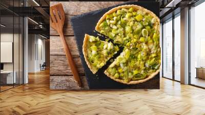 Sliced tart with leek and cheese close-up. Horizontal top view Wall mural