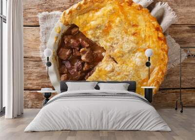 steak pie is a traditional meat pie served in Britain it is made from stewing steak and beef gravy, enclosed in a pastry closeup in the dish on the table. horizontal top view from above Wall mural