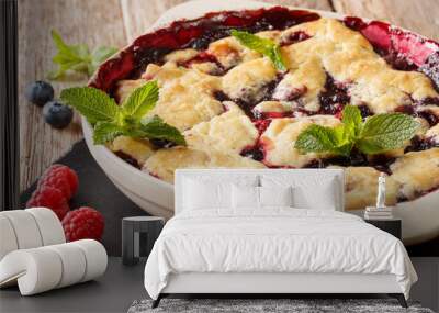 Summer berry cobbler of raspberries and blueberries close up in a dish baking dish. horizontal Wall mural