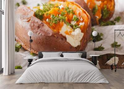 sweet potatoes baked with feta cheese and parsley macro on the table. horizontal Wall mural