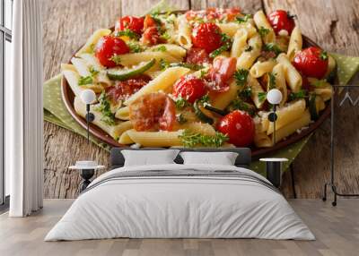 Tasty penne pasta with fried ham, tomatoes, zucchini and Parmesan cheese close-up. horizontal Wall mural