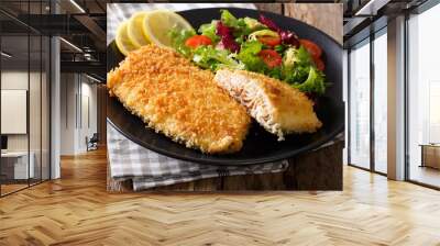 Tasty roasted Fish fillet in breadcrumbs and fresh vegetables close-up. horizontal Wall mural